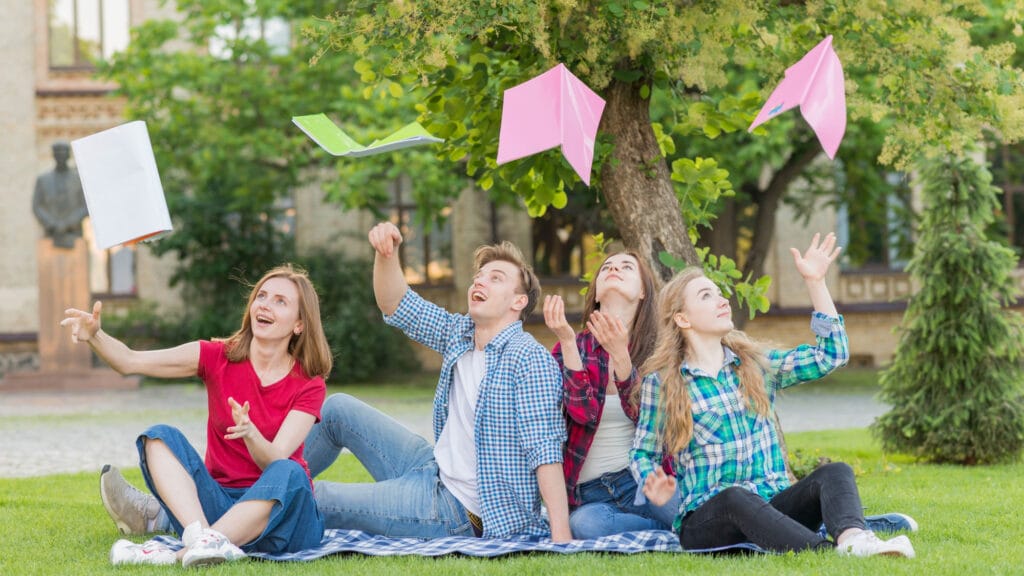 The image shows happy students after receiving Assignment help.